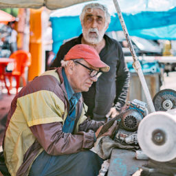 Old men working on antique equipment