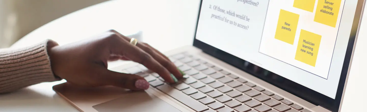 A professional using a laptop showcasing the experience of an innovation workshop.