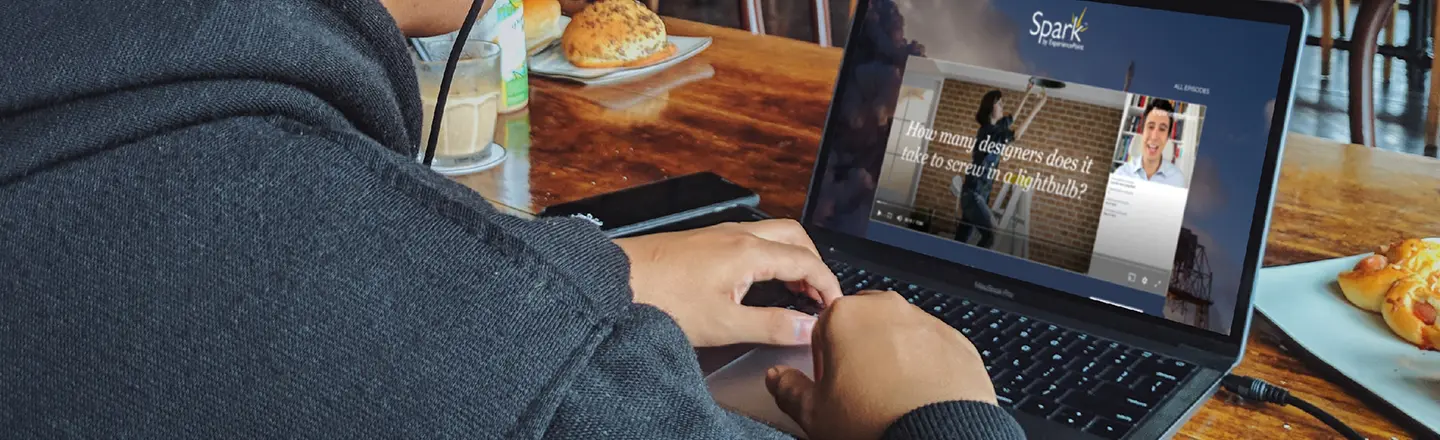 A professional watching a bite-sized learning episode on his laptop during a design thinking training session.