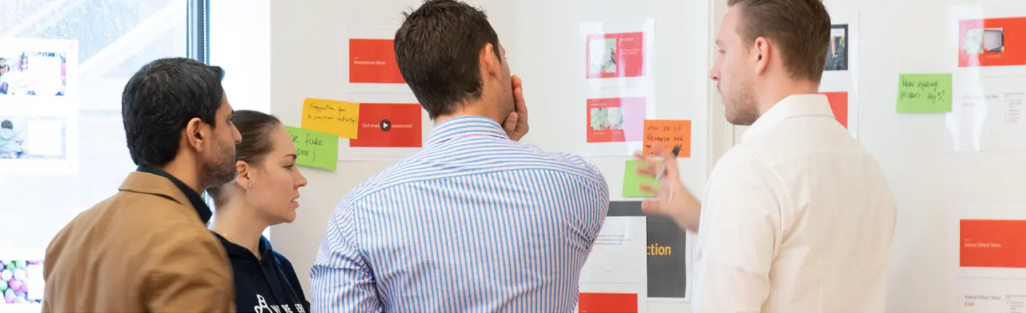 Participants go over their questions on a wall, showcasing how ExperiencePoint's Train the Trainer prepares facilitators.