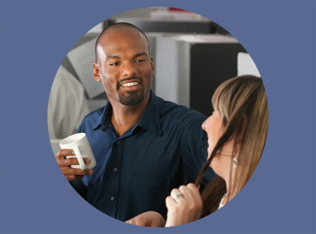 Man having conversation with colleague about increasing engagement.