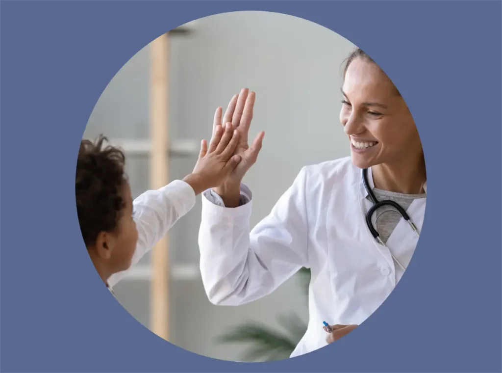 Young patient giving a high five to a doctor.
