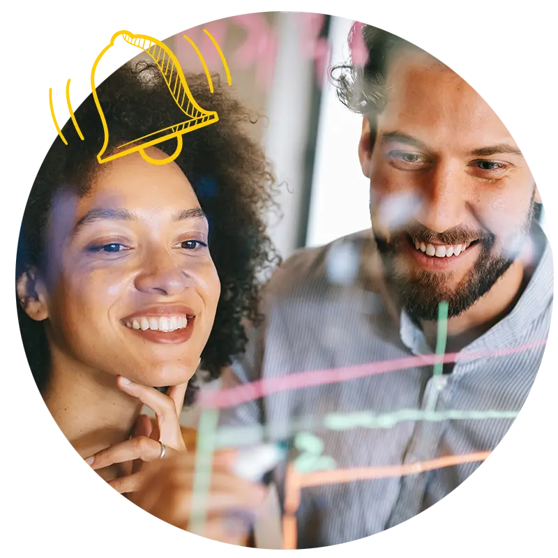 Two people communicating the strategy around AI integration in front of a whiteboard