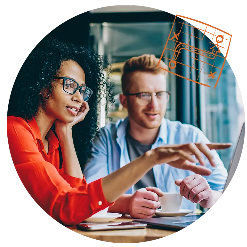 Two people sitting in front of a laptop making a plan on what use cases they an apply AI to