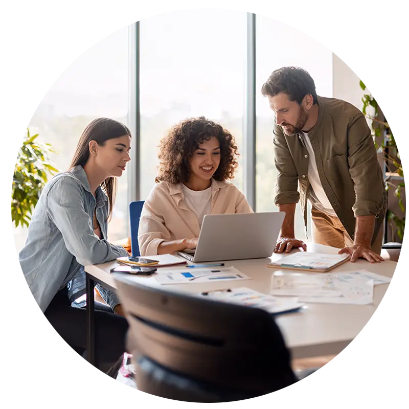 A group of colleagues working with AI on a laptop.