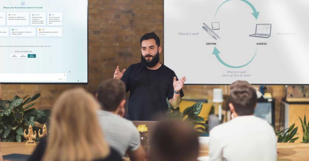 Man talks about the future of leadership development in the age of ai in the front of the room